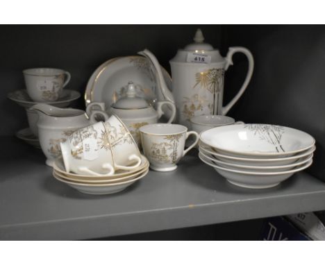 A vintage Japanese coffee set having gilted bamboo designs to white porcelain, comprising twenty pieces.
