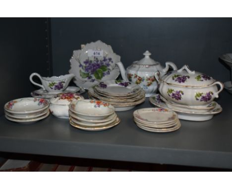 A vintage miniature tea set having violla's to white porcelain sold alongside other miniature saucers and plates.