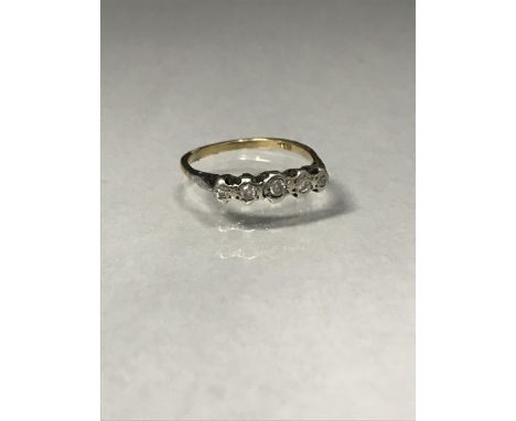 DIAMOND BAND, the five graduated round brilliant cut stones totalling approximately 0.25 carats overall, marked 18ct to the s