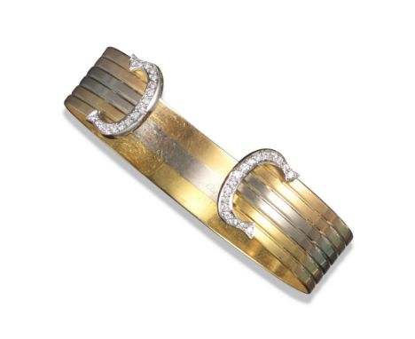 A three colour gold open bangle by Cartier, the striated bangle with diamond-set 'C' terminals, signed Cartier 750, 761597, m