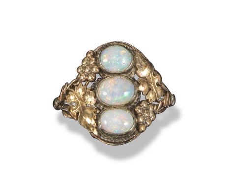 An opal three stone ring, possibly attributed to Edward Spencer, c1905, mounted with three oval opals in vine tendrils and gr