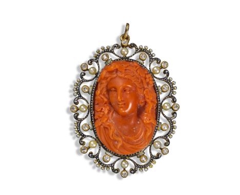 A carved coral cameo-mounted pendant in the style of Giuliano, c1895, the cameo depicting the head of a girl with fruiting vi