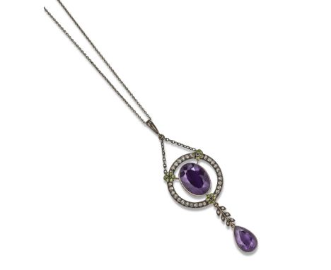 An amethyst, demantoid garnet and white sapphire Suffragette pendant by Child & Child, c1920, the centre oval-shaped amethyst