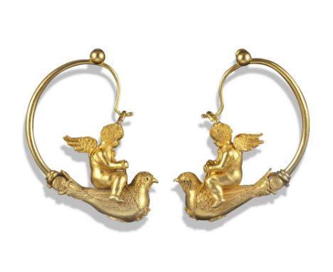 A pair of gold Etruscan Revival earrings attributed to Melillo, c1870, depicting putti riding doves, with large hoop attachme