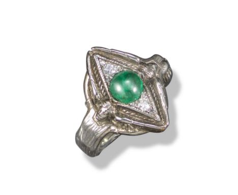 A lozenge-shaped white gold ring by Omar Ramsden, c1925, set with an emerald cabochon and two diamonds within white gold loze