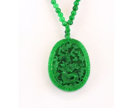 A Chinese carved nephrite jade amulet necklace, L. 5.5cm.