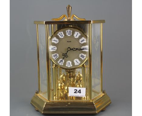 A Kundo gilt brass torsion pendulum clock with engraved glass panels, H. 25cm.
