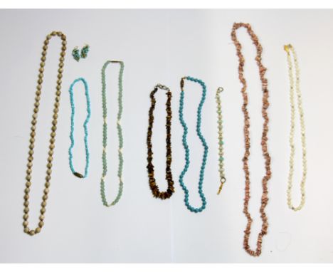 Seven turquoise, tiger's eye, mother of pearl and other semi-precious stone necklaces and a pair of turquoise earrings.