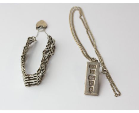 A hallmarked silver gate bracelet (approx 11.3cm) with heart padlock together with a hallmarked silver ingot pendant (approx.