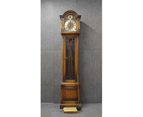 An oak cased longcase clock with St Michael, Whittington and Westminster chimes, presented in 1936, H. 196cm.