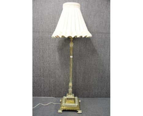 A 19th century brass standard oil lamp stand converted for use with electricity, H. with shade 134cm.