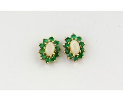 A pair 9ct gold (stamped 375) cluster stud earrings set with cabochon cut opal surrounded by faceted cut emeralds, approx. L.