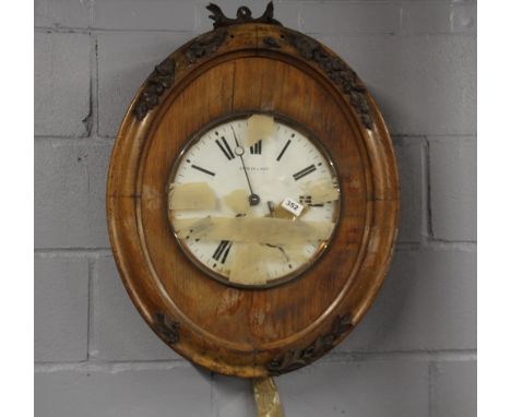 A 19th century Lewis &amp; Son carved wooden wall clock, 69 x 56cm, A/F.