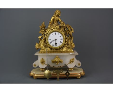 A 19th century French gilt metal and alabaster clock raised on a gilt wooden pedestal, H. 36cm (with base).