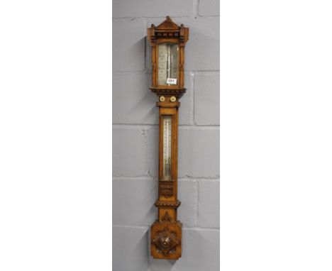A 19th century carved oak mercury barometer by E. Cetti and co, L. 100cm.
