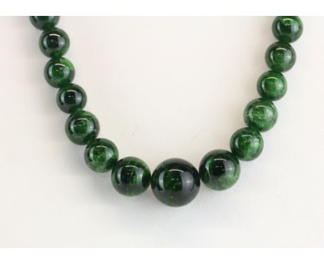 A graduated jade/hardstone bead necklace on a magnetic clasp, L. 50cm.