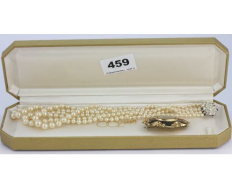 A three row faux pearl necklace with a silver clasp, L. 42cm together with a Victorian yellow metal mourning brooch, L.5.5cm.