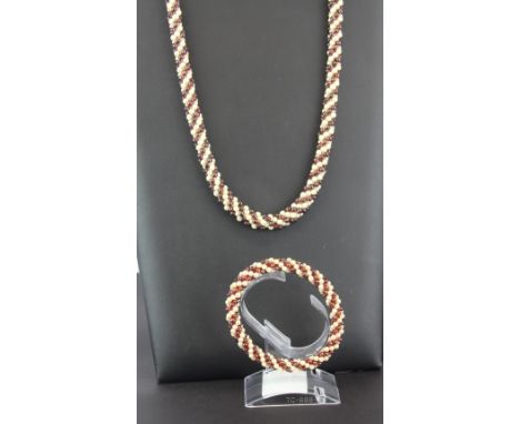A polished garnet beaded pearl necklace and matching bracelet.