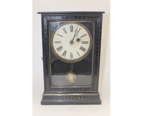 A 19th Century single wind mantel clock, cream dial with Roman numerals, spring loaded, in ebony glass fronted case on plinth