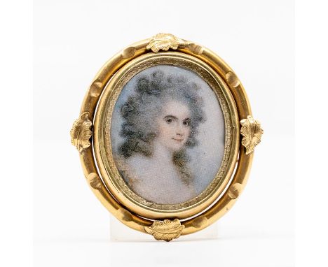 A Victorian gilt metal miniature portrait mourning brooch, female bust to the front with hair reverso, within a border with a