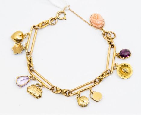 A Victorian 9ct gold charm bracelet comprising alternate open lozenge links and rope twist details, with various charms inclu