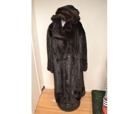 A ranch mink long line fur coat, button through with collar and waist belt, button details to cuffs, circa 1960/70's, length 