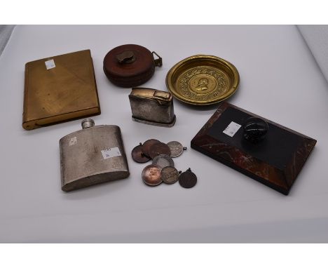 A collector's lot to include: a brass book shaped table cigarette box; an EPNS engine turned hip flask; a brass medallion pla