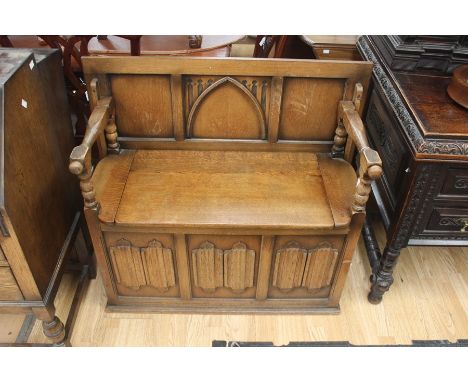 A 20th Century Jacobean style oak Monks bench, with box section to seat