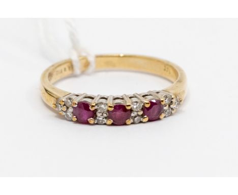 A ruby and diamond 9ct gold half set eternity ring, comprising three round cut rubies with double diamond set accents, claw s