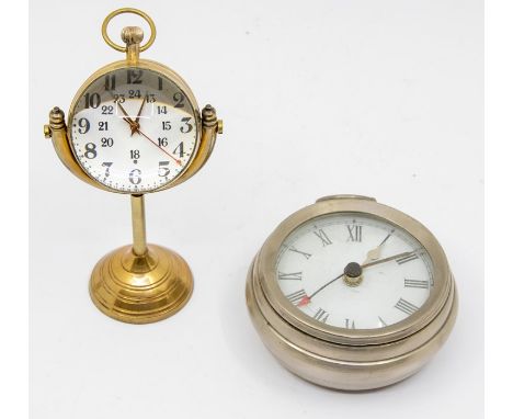 A brass table clock in the form of a pocket watch with magnified dial, white metal travel clock in the form of a Goliath pock
