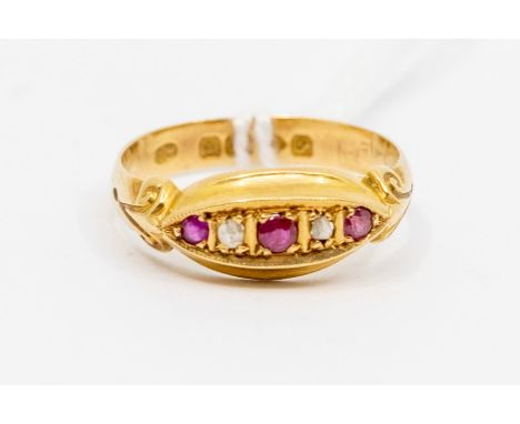 An early 20th Century ruby and 18ct gold boat head ring, set with three rubies and diamond set accents, scrolled shoulders, s