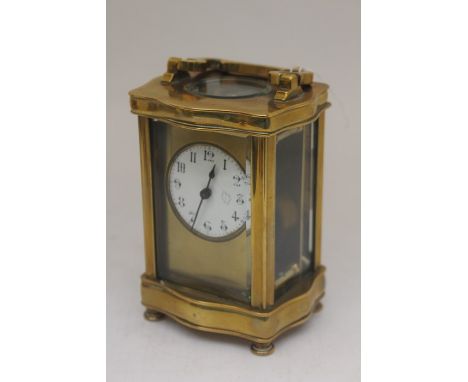 Early 20th Century French brass carriage clock with small round face and Arabic numerals with key and in working order