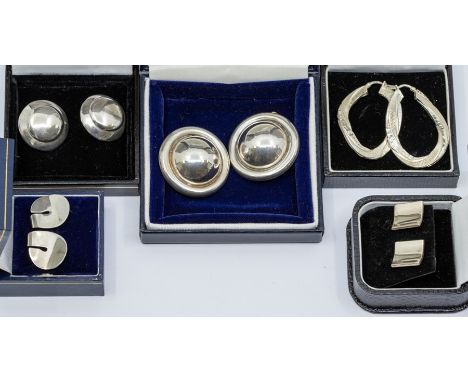 A collection of various silver earrings to include a pair of button domed clip on earrings along with a smaller similar pair,