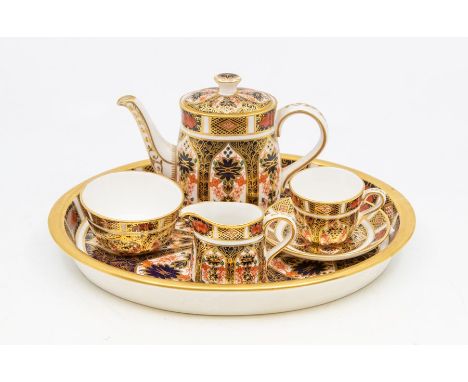 A Royal Crown Derby Imari 1228 (date: XIV) red mark miniature tea service comprising: teapot and cover, cup and saucer, milk 