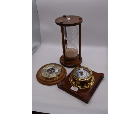 A large 20th Century egg timer along with two wall barometers&nbsp;