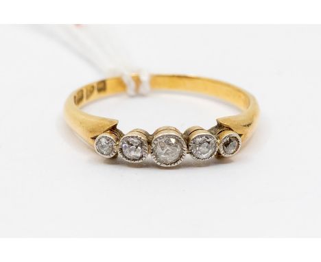 An Edwardian five stone diamond 18ct gold ring, comprising graduated cushion cut diamonds, silver settings with milled border