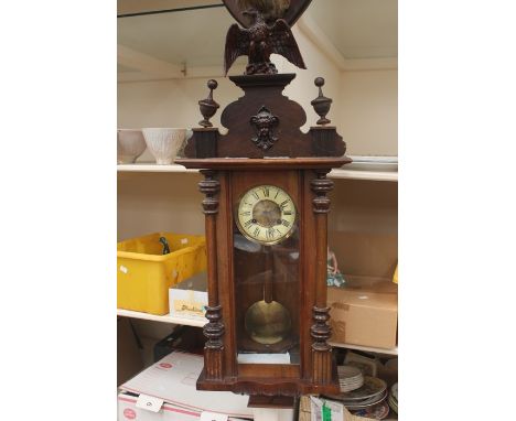 Late 19th Century 8 day German wall clock, in mahogany with eagle design top