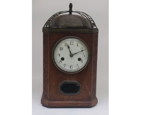 A 1930s oak cased mantel clock, steel dome bell to top, white face with black Arabic numerals&nbsp;