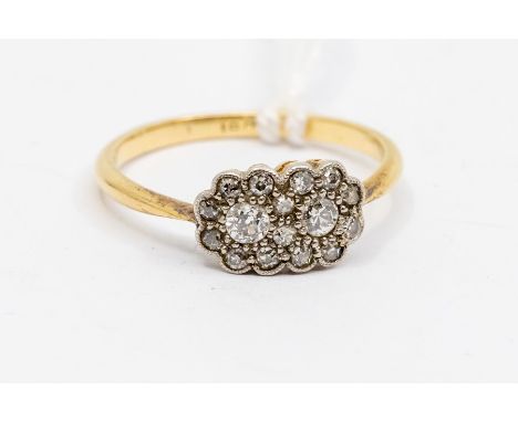 An Edwardian and diamond set floral 18ct gold cluster, comprising two entwined daisy clusters, total diamond weight approx 0.