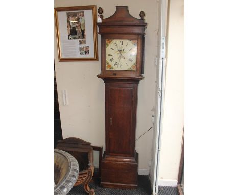 An early 19th Century oak 30 hour longcase clock, indistinctly signed, having a 12 inch dial with black Roman numerals, flora