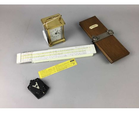 MILITARY POCKET COMPASS,along with a carriage clock, vintage slide rule and a tie press (4)