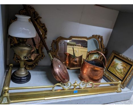 A mixed lot of metalware and mirrors to include brass extending fire fenders, copper coal scuttle, brass oil lamp with shade,