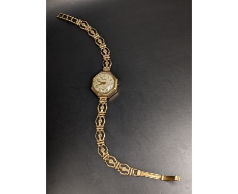 A Ladies Pioneer 9ct gold manual wind watch on a 9ct gold bracelet, weight 14.1g 