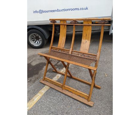 A Chinese folding elm bench with a double splat-back and string seatLocation: 