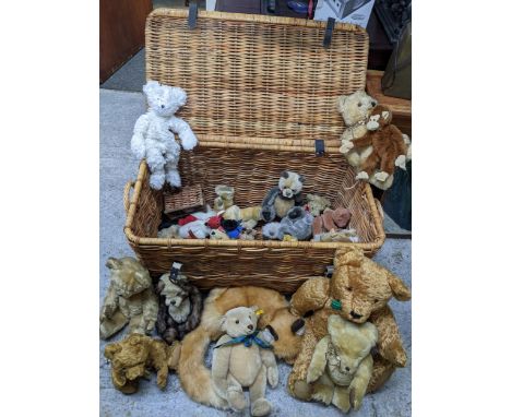 A wicker basket containing a collection of vintage teddy bears including Chad Valley, Herman, Steiff bears, Boyds monkey, Cha