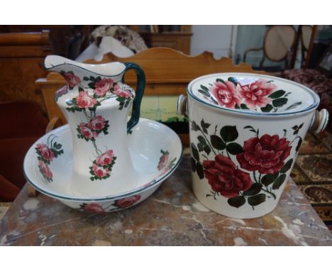 BRISTOL G.S. POTTERY AFTER WEMYSS: An early 20th Century part washstand set comprising jug, basin and slops pail, painted wit