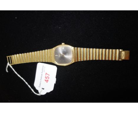 LONGINES: A gentleman's gold plated quartz wristwatch, the dial with button numerals and date aperture, attached to a yellow 