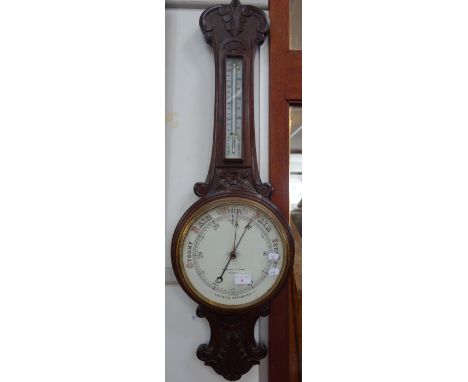 A VICTORIAN CARVED WALNUT ANEROID BAROMETER, the dial marked 'Marshall &amp; Sons Newry'
