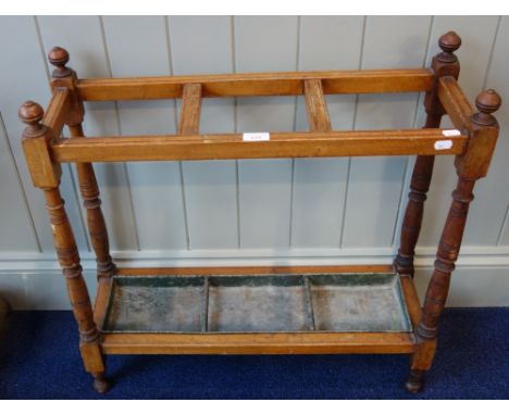 A LATE VICTORIAN WALNUT STICK STAND