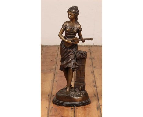 A large bronze figure of a girl, shown in standing pose playing a mandolin, h.68cm